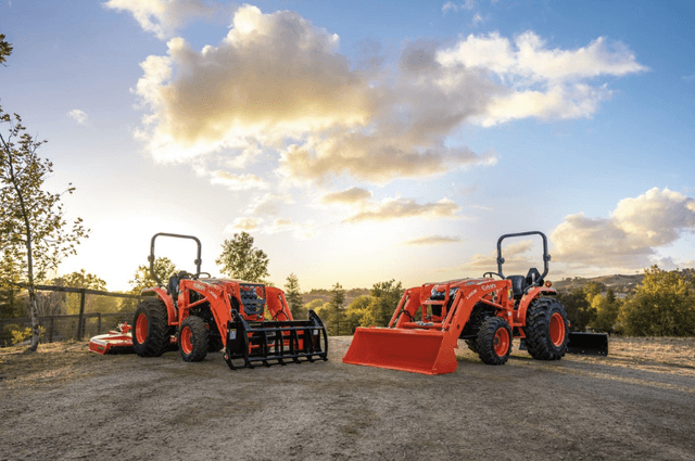 Two tractors pictured in front of a beautiful sunset
