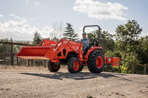 Man driving a tractor down dirt road