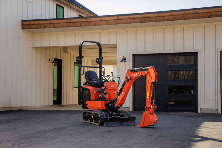 Kubota K008-5 staged in front of a home