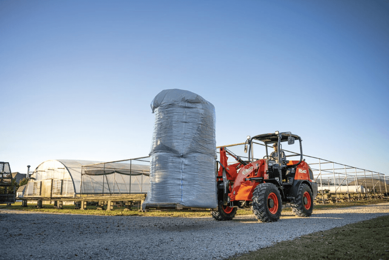 Wheel Loader moving pallet of materials