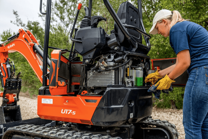 Woman servicing an excavator