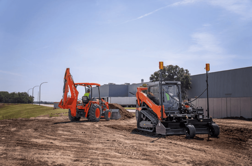 A tractor loader backhoe and a track loader on a work site