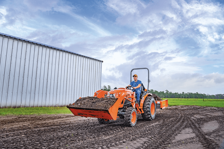 Man driving a tractor through mud