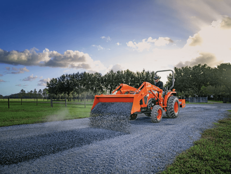 Tractor dumping gravel onto driveway